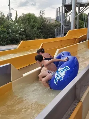 two girls are sitting in an inner tube in the water at Appartement avec balcon/terrasse in Monteux