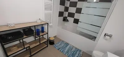 a bathroom with a bath tub in a room at Appartement avec balcon/terrasse in Monteux