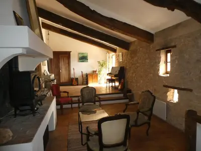 a living room with chairs and a fireplace at Le Jas des aiguiers in Saint-Saturnin-les-Apt