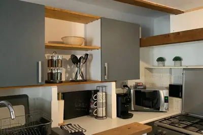 a kitchen with a counter with a microwave and a stove at Duplex à Monteux centre, 5 couchages distincts, LOCAL VELOS in Monteux