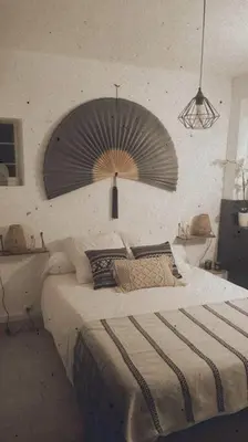 a bedroom with a bed with a fan on the wall at Appartement duplex toit terrasse in Apt