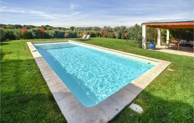 a swimming pool in the grass in a yard at Stunning Home In Pernes-Les-Fontaines in Pernes-les-Fontaines