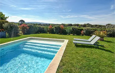 a pool in a yard with a bench next to it at Stunning Home In Pernes-Les-Fontaines in Pernes-les-Fontaines