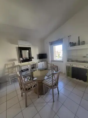 a dining room with a table and chairs at Appartement au Cœur de la Sorgue in LʼIsle-sur-la-Sorgue