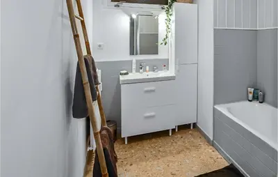 a bathroom with a sink and a mirror and a tub at Nice Apartment In Carpentras With Wifi in Carpentras