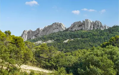 a mountain with trees and rocks in the background at Nice Apartment In Carpentras With Wifi in Carpentras