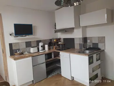a small kitchen with white cabinets and a sink at la maison de josy in Aix-en-Provence