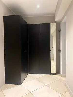 a black closet in a room with a mirror at La Bastide des Rosiers in Mallemort