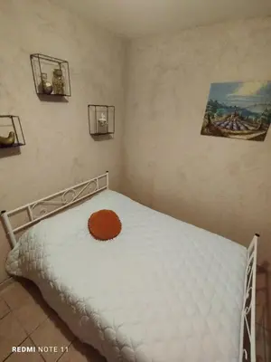a bedroom with a bed with a white mattress at Chambre d hôtes en Provence, au pied du Luberon, les Coquelicots in La Tour-dʼAigues