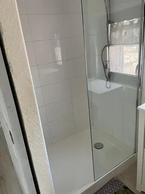 a shower with a glass door in a bathroom at La terrasse de Caromb face au Mont VENTOUX maison avec clim in Caromb