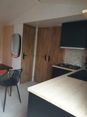 a kitchen with a counter top and a stove top oven at Camping Domaine des Iscles in La Roque-dʼAnthéron
