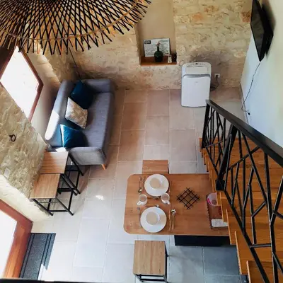 an overhead view of a living room with a couch and a table at Le Cabanon des Lavandes entre Mont Ventoux et Luberon in Sault-de-Vaucluse