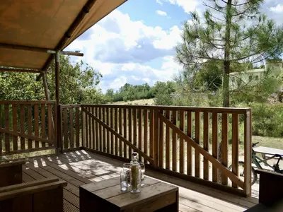 a wooden deck with a table on top of it at La Grisonne - Chalet3 in Revest-du-Bion