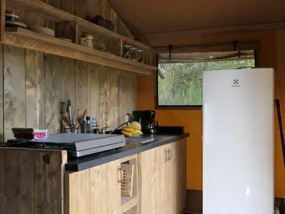 a kitchen with wooden cabinets and a white refrigerator at La Grisonne - Chalet3 in Revest-du-Bion