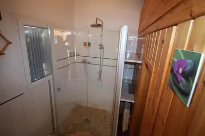 a shower with a glass door in a bathroom at Gîte Les Hauts Sauviers avec piscine et sauna in Bédoin