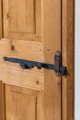 a wooden door with a metal latch on it at Maison style mas « le rougadou » in Noves