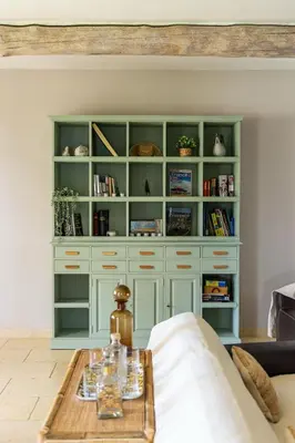 a living room with a large book shelf at Maison style mas « le rougadou » in Noves