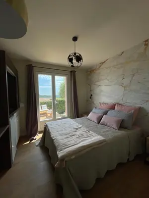 a bedroom with a large bed and a large window at Chambre d'hôtes avec Jacuzzi Ventoux Cocoon in Bédoin