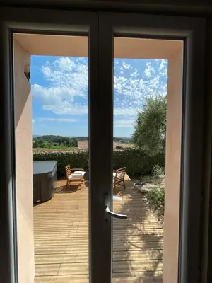 an open door with a view of a patio at Chambre d'hôtes avec Jacuzzi Ventoux Cocoon in Bédoin