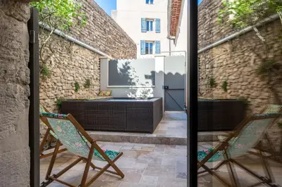 a patio with two chairs and a table at La Grange de la Chèvre d'Or in Lagnes