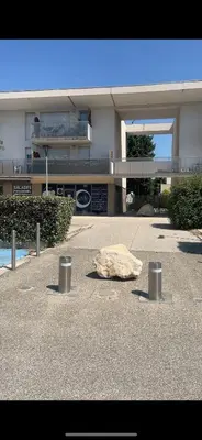 a rock on the ground in front of a building at Appartement Studio en résidence Avignon zone Agroparc in Avignon