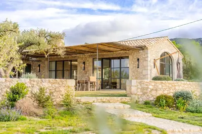 a stone house with a stone wall at Mas La Bergerie in Eygalières