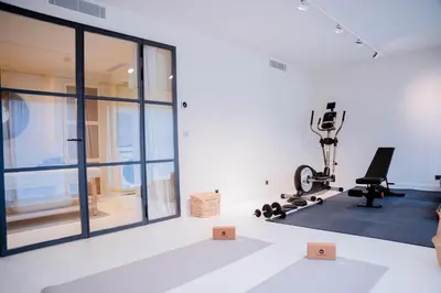 an empty room with a gym with a treadmill and a exercise bike at Mas La Bergerie in Eygalières