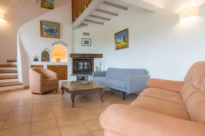 a living room with a couch and a table at Le Mas du Miel d'Or, 12 pers, au coeur du Luberon, air-conditionné, piscine, propriété de 5000 m2 in Villars