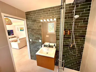 a bathroom with a sink and a shower at Paisible studio tout neuf en lisière de forêt in Peyrolles-en-Provence