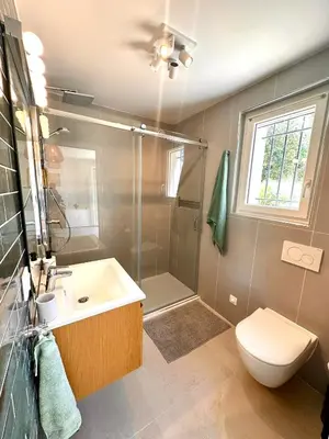 a bathroom with a shower and a toilet and a sink at Paisible studio tout neuf en lisière de forêt in Peyrolles-en-Provence