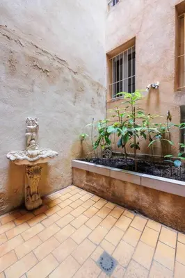 a building with a fire hydrant next to a window at Au cœur d’Aix-en-Provence in Aix-en-Provence