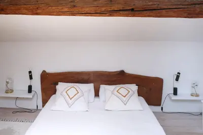 a bedroom with a white bed with white pillows at Superbe Mas contemporain au pied du Luberon in Cheval-Blanc