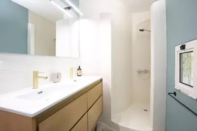 a white bathroom with a sink and a shower at Superbe Mas contemporain au pied du Luberon in Cheval-Blanc
