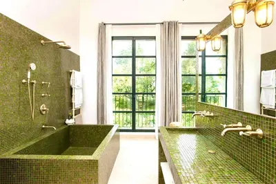 a bathroom with a green tub and a large window at La Grande Verrière - Luberon en Provence in Goult