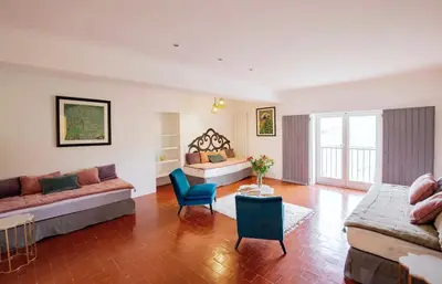a living room with two beds and a couch at La Grande Verrière - Luberon en Provence in Goult