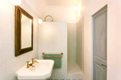 a white bathroom with a sink and a mirror at La Grande Verrière - Luberon en Provence in Goult