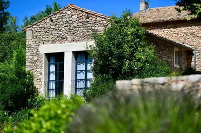 a stone house with a window on the side of it at La Grande Verrière - Luberon en Provence in Goult