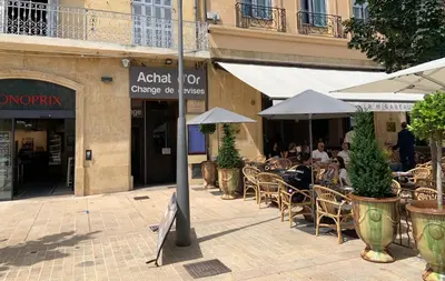 a group of people sitting at an outdoor restaurant at Studio de Luxe Aix en Provence in Aix-en-Provence