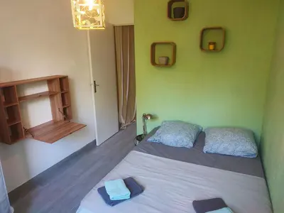 a bedroom with a bed with two towels on it at Grand appartement de charme calme et lumineux parking compris in Aix-en-Provence