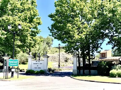 a gate at the entrance to a park with trees at Maison Calme 6 Pers. au Golf Pont Royal - Piscine, Terrasse, Parking, Clim, Fibre - 13370 Mallemort - FR-1-658-24 in Mallemort