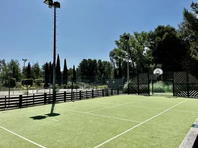 a tennis court with a light on top of it at Maison Calme 6 Pers. au Golf Pont Royal - Piscine, Terrasse, Parking, Clim, Fibre - 13370 Mallemort - FR-1-658-24 in Mallemort