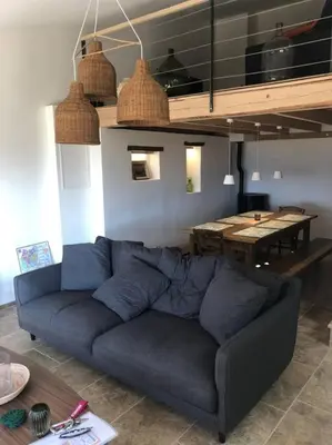 a living room with a blue couch and a table at Le Jas Gabriel in Murs