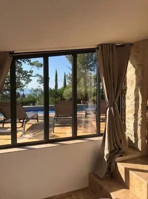a room with a window with a view of a patio at Le Jas Gabriel in Murs