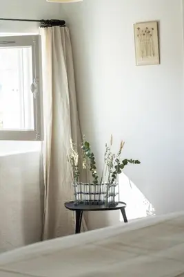 a bedroom with a bed and a table with flowers at La Bastide du Mourre - Fontenille Collection in Oppède