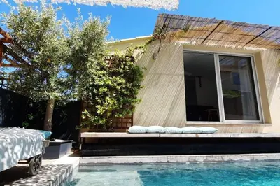 a house with a swimming pool next to a house at Maison de village 4 étoiles avec piscine privee in Villars