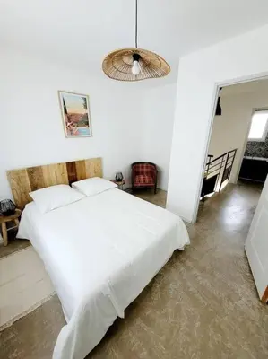a bedroom with a large white bed in a room at Maison de village 4 étoiles avec piscine privee in Villars