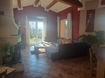 a living room with a couch and a table at Magnifique Villa avec piscine in Cadenet
