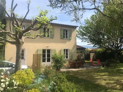 a house with a garden in front of it at Maison familiale au pied du Mont Ventoux in Mazan