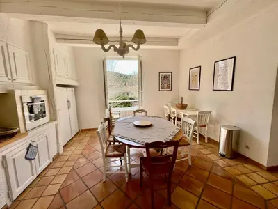 a kitchen and dining room with a table and chairs at Notre Dame des Anges DUPLEX in Rustrel
