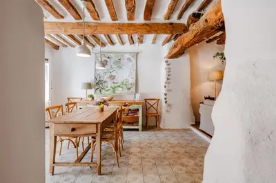 a dining room with a wooden table and chairs at Chez Fanny in Bédoin